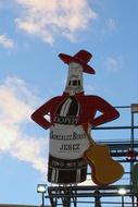 a sign with a guitar on the roof