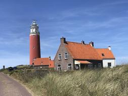 a brick lighthouse and a house