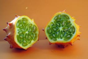 a green fruit with an orange spiked