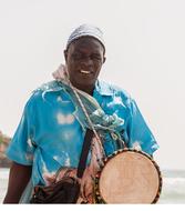 a man with a drum in a blue shirt