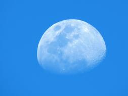 A full moon in a blue sky