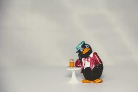 penguin at the bar with a glass