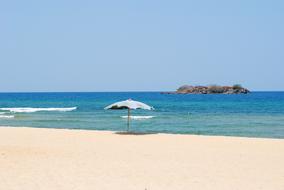 beach umbrella on the sea sand