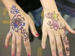 colored mehndi on girls hands close-up