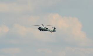 Flying helicopter, in the colorful and beautiful sky with clouds, in Hamburg, Germany