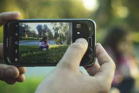 person with Smartphone taking photo of Girl