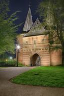 aged City Gate at night