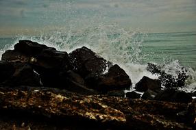 wave crashing on Beach Rocks