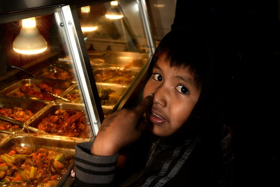 cute baby near a food display case