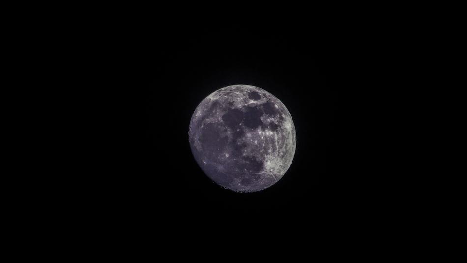 a magnificent moon in a black sky
