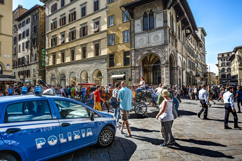 the blue car and the people in the square