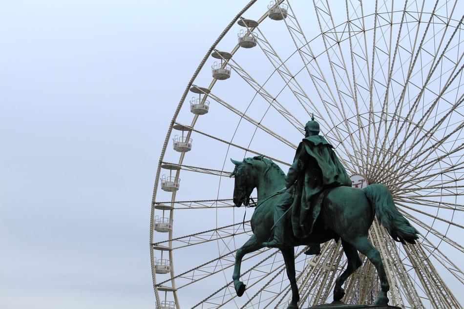 Beautiful green national monument to Kaiser Wilhelm I against the background of the Ferris wheel in Berlin