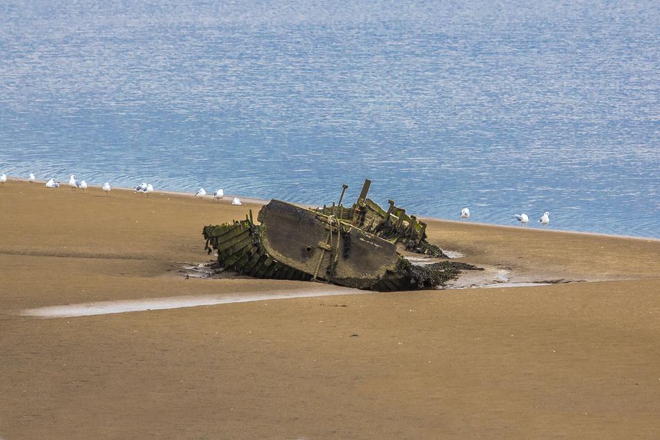 old ship on the beach by the sea