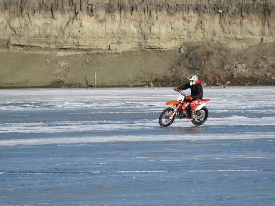 man on a motorcycle in the winter woods