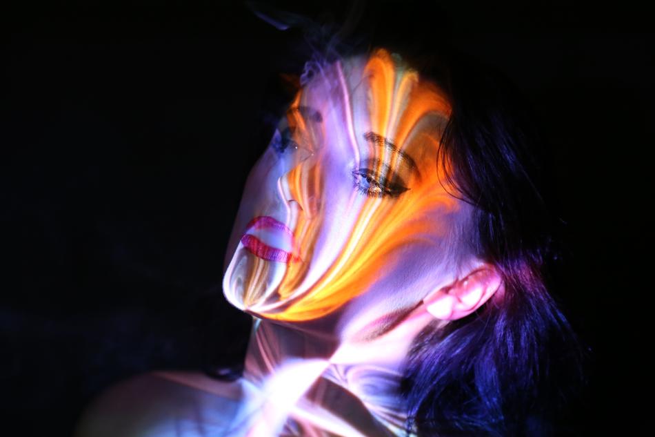 a woman in a colored glow