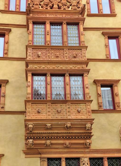 wooden balconies on the yellow house