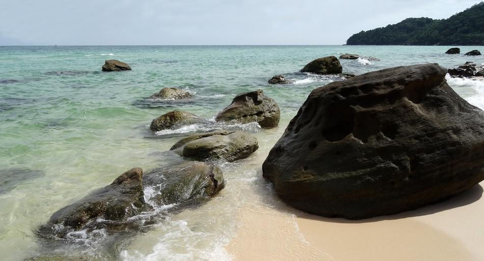 black rock by the waves of the sea