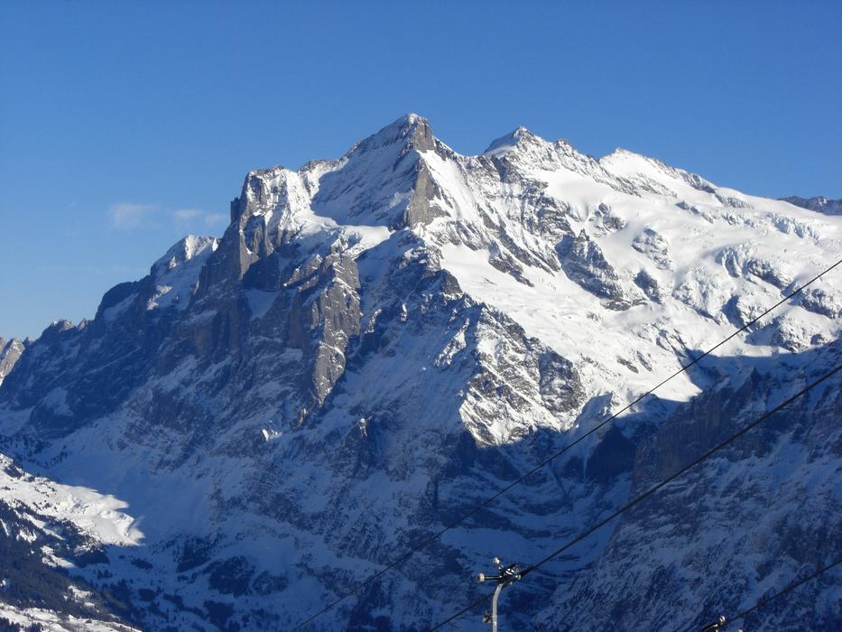snowy high mountain against a blue background