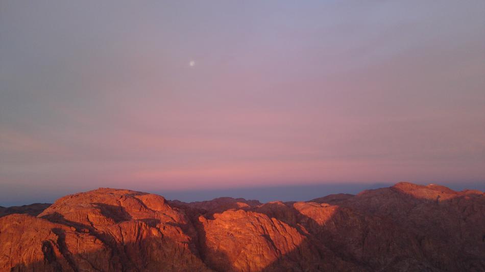 red sky with mountains in the sun
