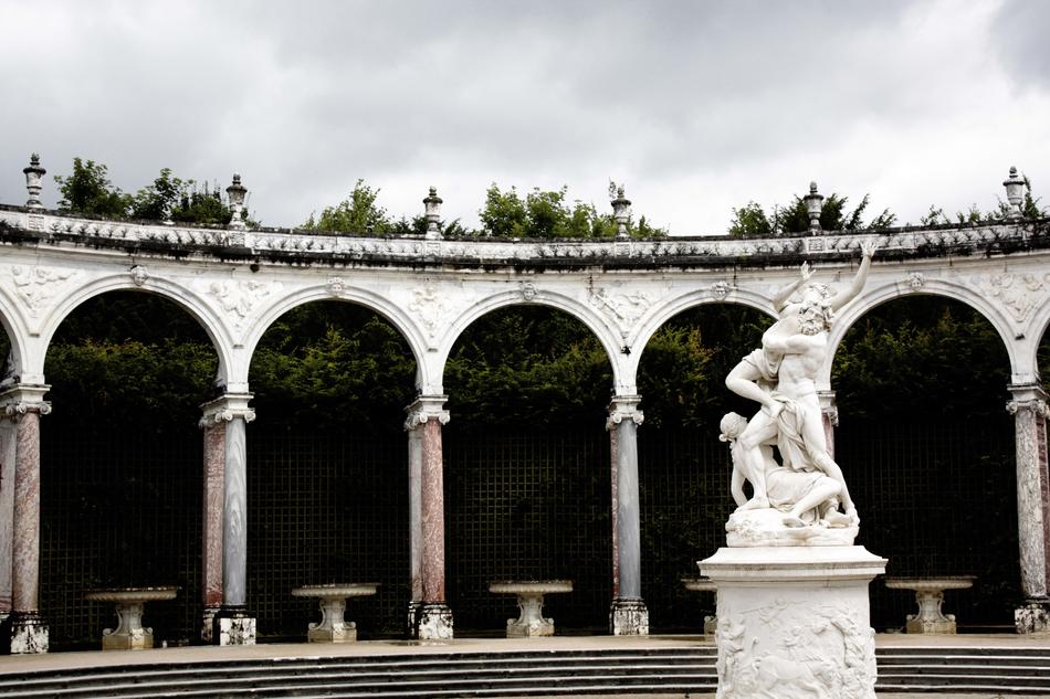 sculpture in the park with arches fence