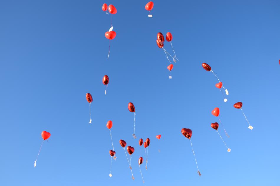 red balloons in a blue sky