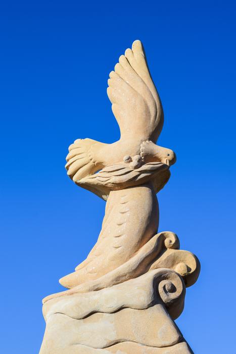 white sculpture on a blue background