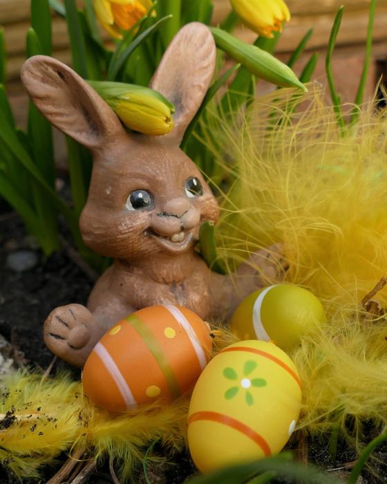 bunny figurine with eggs and fir trees