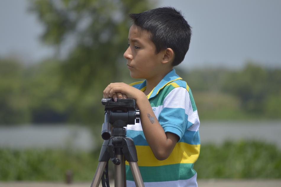 Boy child near the camera tripod