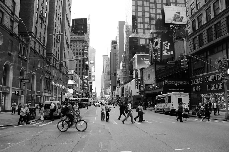 monochrome photo of people on a street in New York