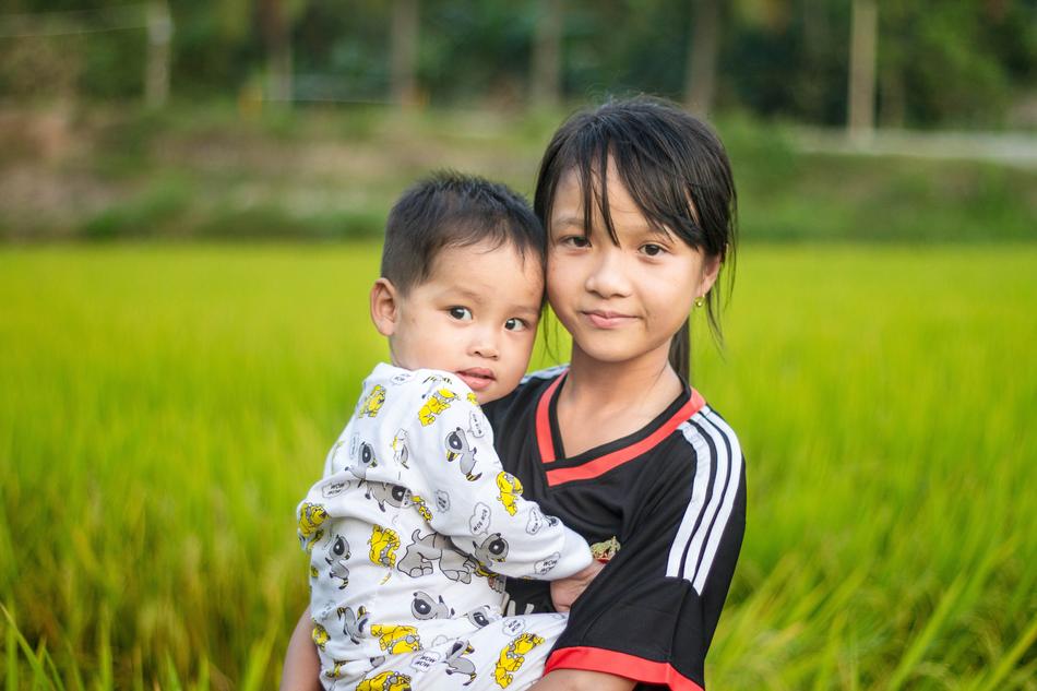 Asian kids by the grass