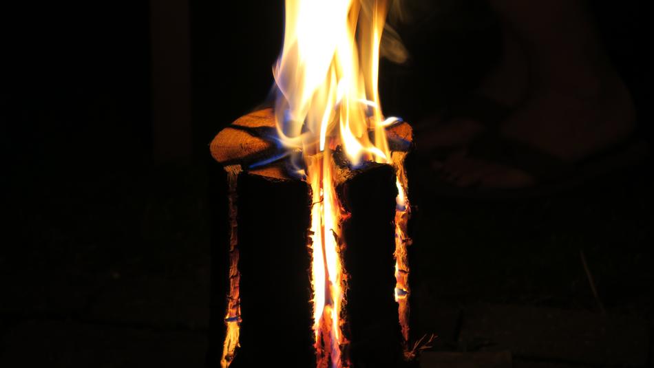 a burning fire in an iron barrel