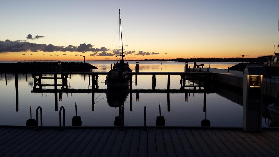 the silhouette of a ship in the water