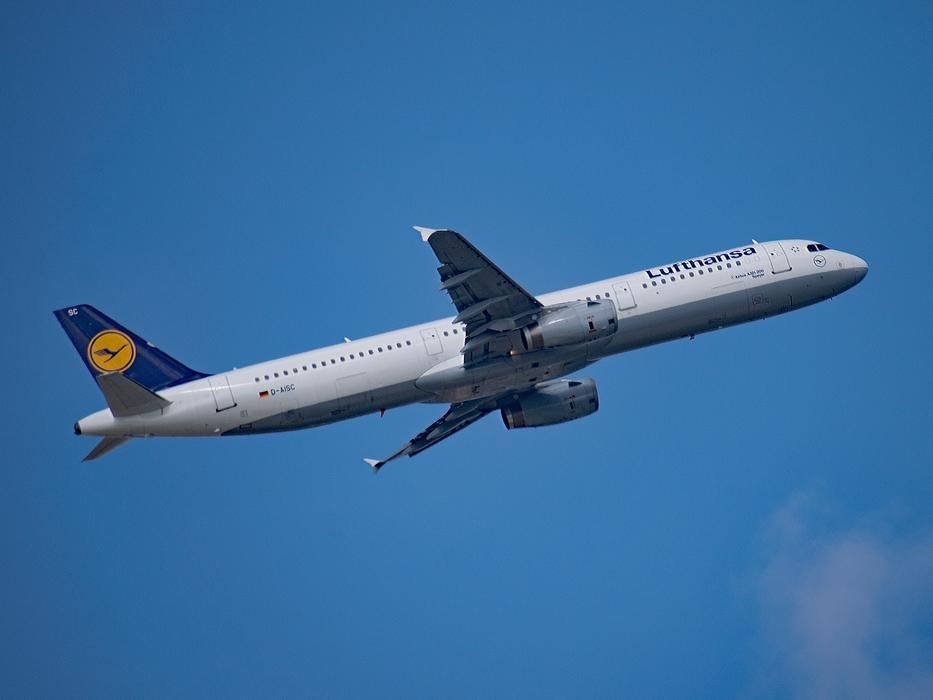 A white plane in a blue sky
