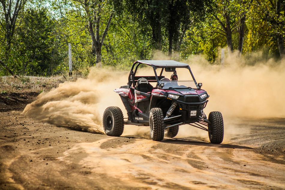 the car is driving in the sand