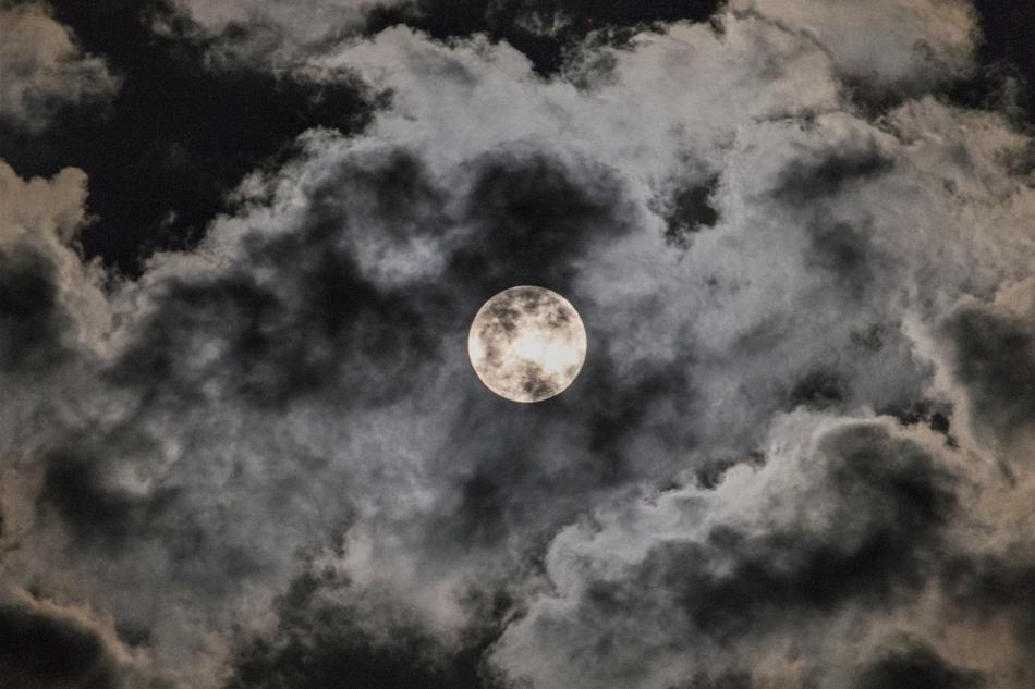 white moon with black clouds