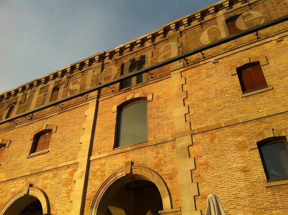 brick house with windows and an arch