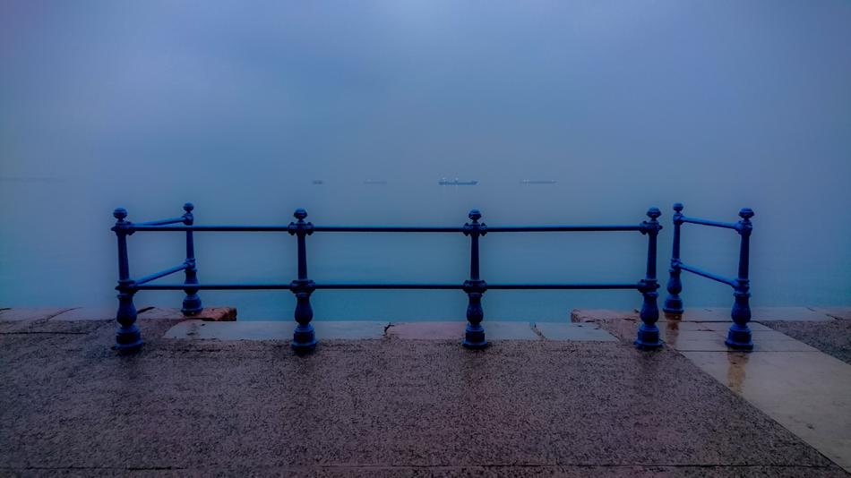 the blue sea with a fence