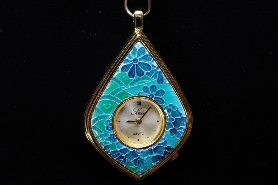 a blue keychain with a watch