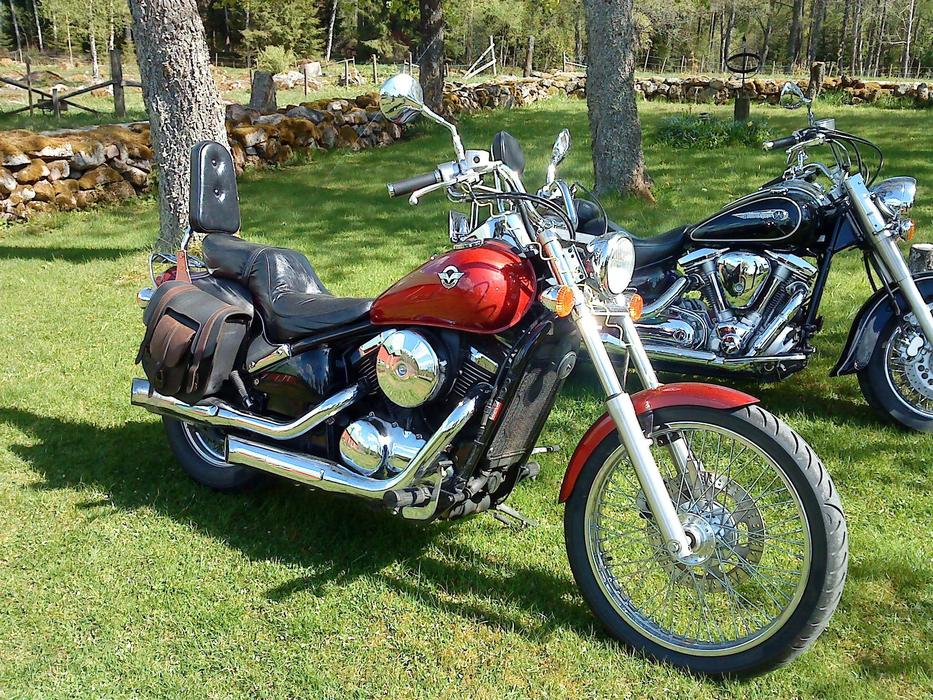 A red motorcycle in a meadow