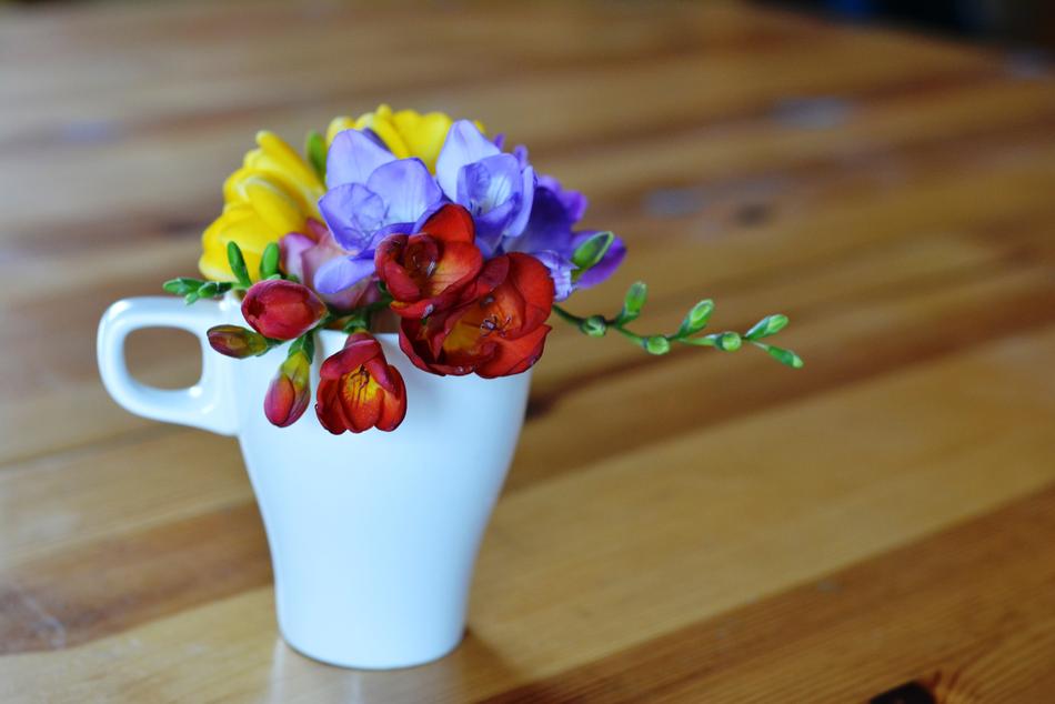 flowers in a mug on the table
