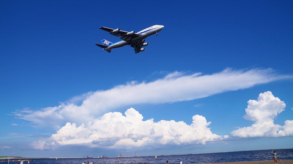a plane flying far away against the background of clouds