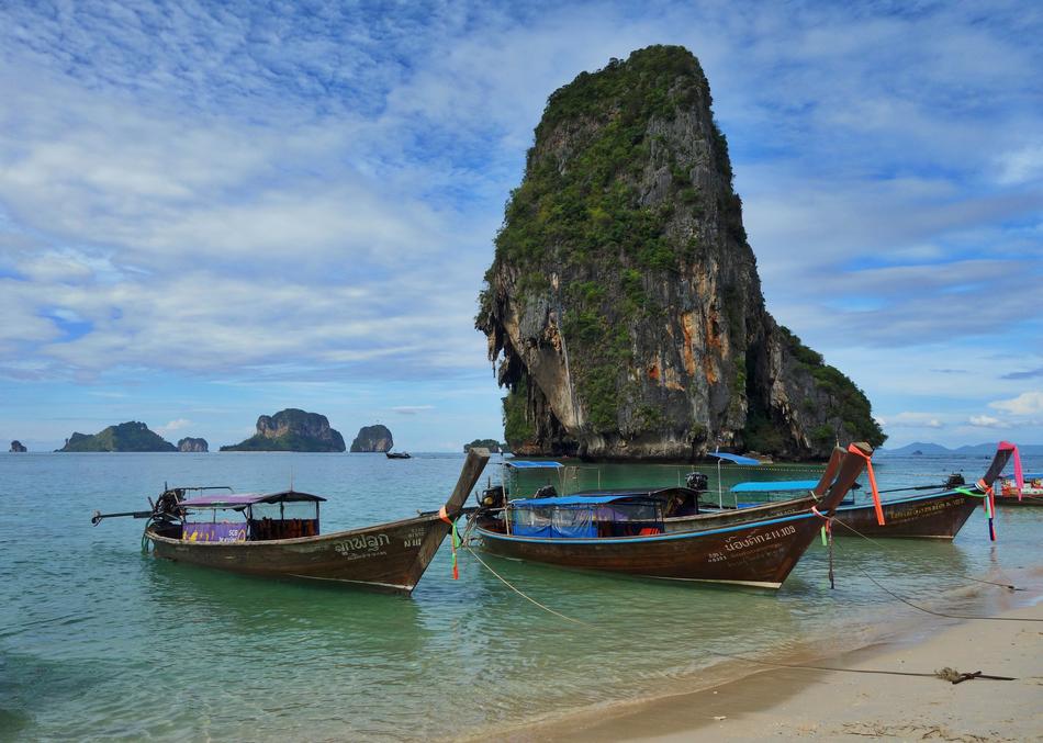 green big mountain with boats