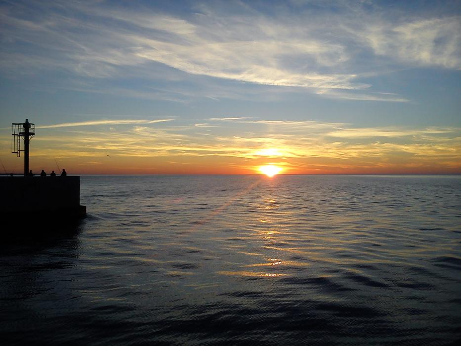 sun in the clouds with the sea
