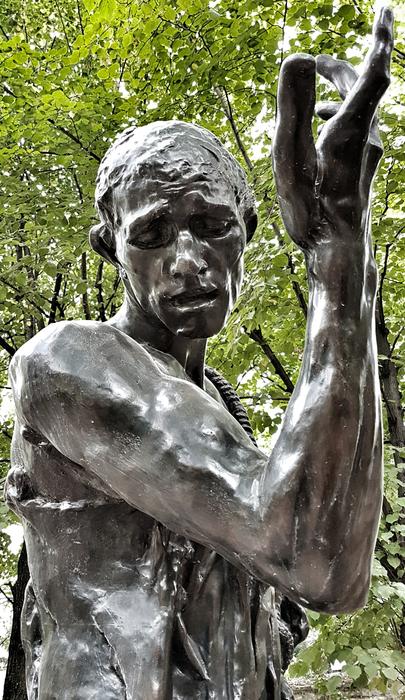 silver sculpture of a man in pain