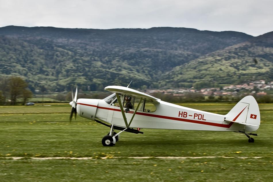 an airplane taking off on green grass