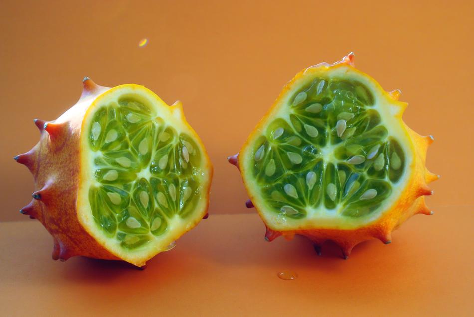 a green fruit with an orange spiked