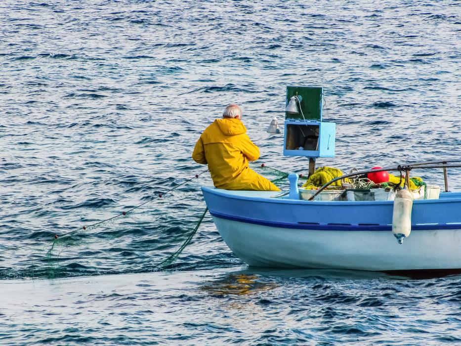 a man is a fisherman on a boat