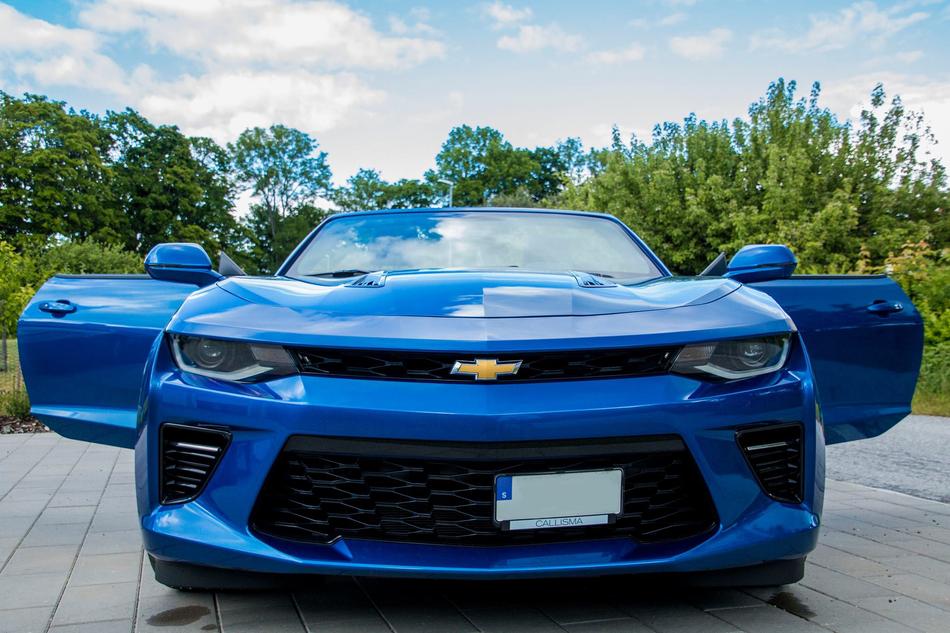 a blue car with the doors open