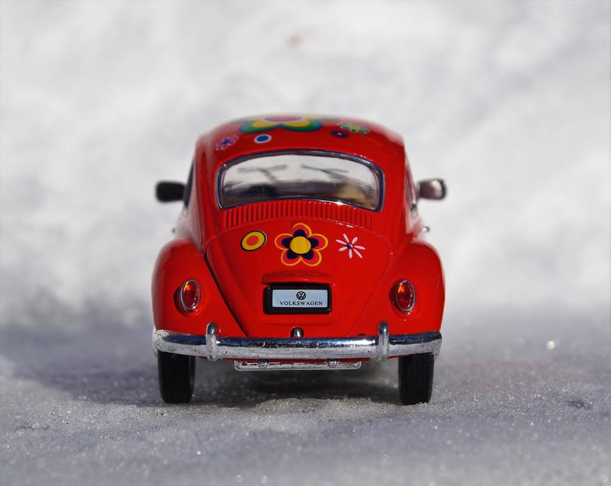 The car model is red on a white background