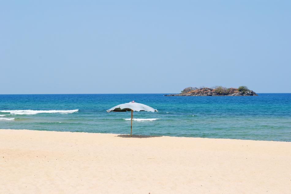 beach umbrella on the sea sand